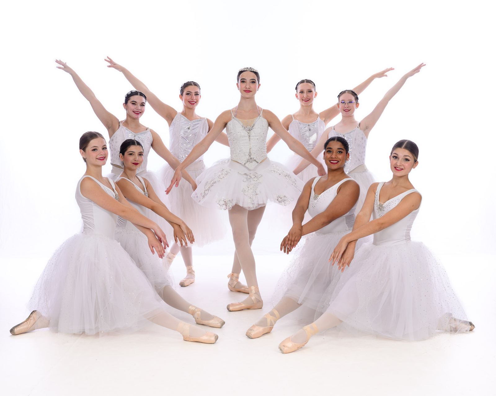 Spokane ballet dancers in white tutus posing for a group studio portrait